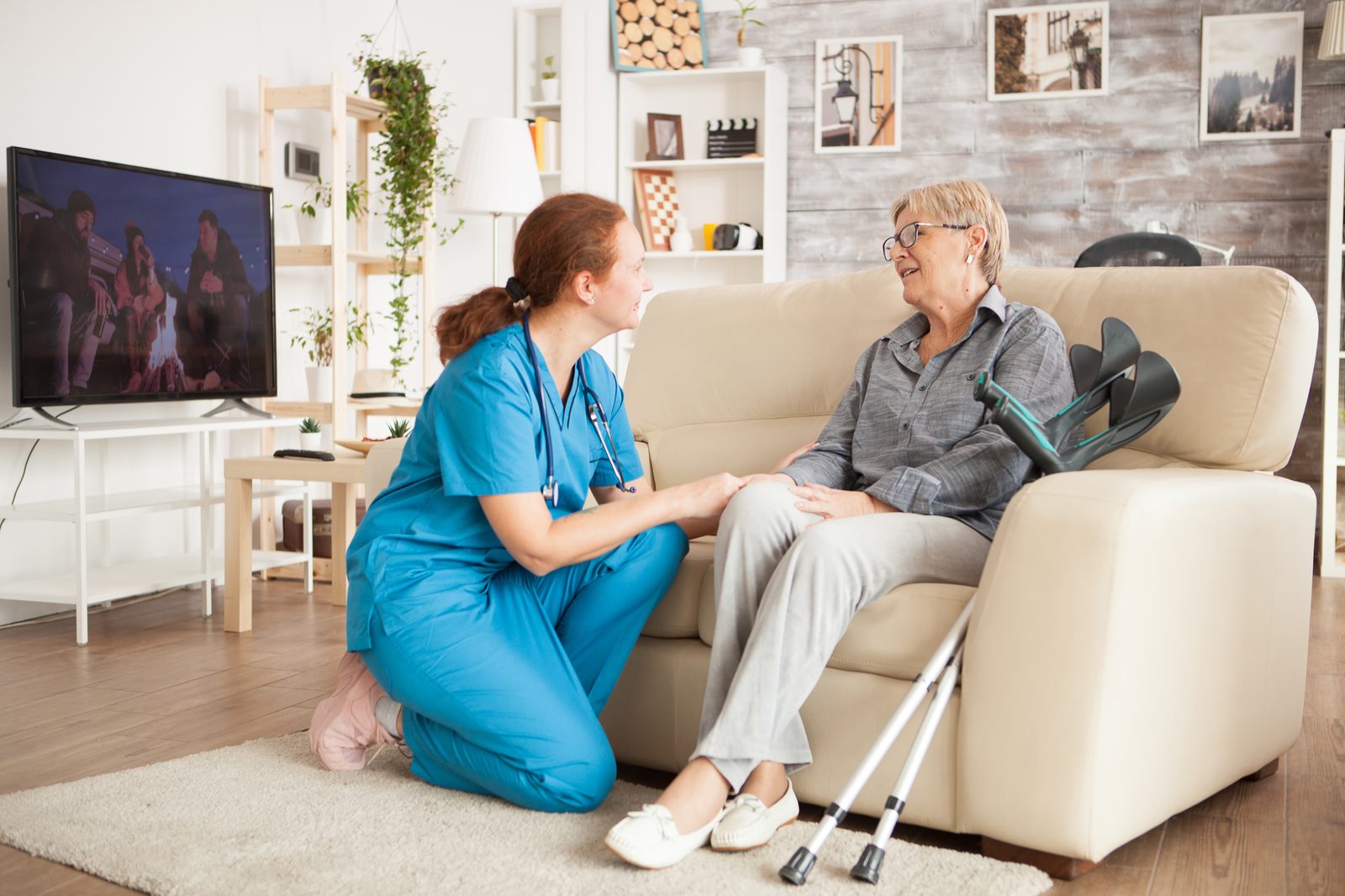 A care navigator visiting a senior at home after discharge